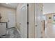 Neutral-toned hallway with access to laundry room, living area, and exit to backyard at 18045 W Rimrock St, Surprise, AZ 85388