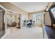 Bright home office featuring french doors, desk, and a view to the living room at 18045 W Rimrock St, Surprise, AZ 85388