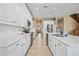 Bright kitchen with white cabinets, marble countertops and backsplash, and stainless steel appliances at 18045 W Rimrock St, Surprise, AZ 85388