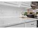Close-up of marble countertop and white subway tile backsplash with stainless steel microwave and oven at 18045 W Rimrock St, Surprise, AZ 85388