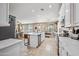 Spacious kitchen with a central island and stainless steel appliances opens to the breakfast nook and living room at 18045 W Rimrock St, Surprise, AZ 85388