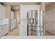 Kitchen featuring white cabinets, stainless steel fridge, and marble countertops at 18045 W Rimrock St, Surprise, AZ 85388