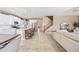 Open-concept kitchen features white cabinetry, stainless appliances, large island, and adjacent living spaces at 18045 W Rimrock St, Surprise, AZ 85388
