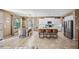 Open-concept kitchen and dining area features tile floors, white cabinets, and stainless steel appliances at 18045 W Rimrock St, Surprise, AZ 85388