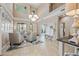 Elegant living room boasts high ceilings, a chandelier, comfortable seating, and abundant natural light at 18045 W Rimrock St, Surprise, AZ 85388