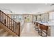 Open living space featuring a modern kitchen island with bar stools, a cozy living area, and natural light throughout at 18045 W Rimrock St, Surprise, AZ 85388