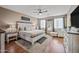 Relaxing main bedroom featuring wood floors, ceiling fan, and calming colors at 18045 W Rimrock St, Surprise, AZ 85388
