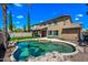A beautiful backyard featuring a rock-lined pool, lush artificial turf, and a spacious two-story home at 18045 W Rimrock St, Surprise, AZ 85388