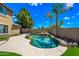 Sparkling pool with rock accents is surrounded by lush landscaping, providing a serene backyard retreat at 18045 W Rimrock St, Surprise, AZ 85388