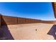A zero-scaped backyard is enclosed by a block wall at 20262 W Monterey Way, Buckeye, AZ 85396