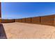 A zero-scaped backyard is enclosed by a block wall at 20262 W Monterey Way, Buckeye, AZ 85396