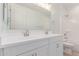 Bright bathroom features a double sink vanity and shower over tub with tile surround at 20262 W Monterey Way, Buckeye, AZ 85396