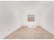 A bright bedroom with wood-look tile floors and a window at 20262 W Monterey Way, Buckeye, AZ 85396