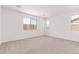 Spacious bedroom with plush carpeting and natural light from the windows at 20262 W Monterey Way, Buckeye, AZ 85396