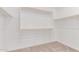 Walk-in closet with ample shelving and a neutral carpet at 20262 W Monterey Way, Buckeye, AZ 85396
