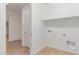 A bright laundry room including utility sink and built-in shelving at 20262 W Monterey Way, Buckeye, AZ 85396