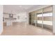 Open living space with ceramic tile flooring and large sliding glass doors leading to the outdoor area at 20262 W Monterey Way, Buckeye, AZ 85396