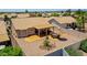 Aerial view of a backyard with a stone patio, desert landscaping and a covered patio at 20739 N 106Th Ave, Peoria, AZ 85382