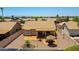 Aerial view of a backyard with a stone patio, desert landscaping, and a covered patio at 20739 N 106Th Ave, Peoria, AZ 85382