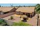 Aerial view of a backyard with a stone patio, desert landscaping, and a covered patio at 20739 N 106Th Ave, Peoria, AZ 85382