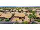 Aerial view of a backyard with a stone patio, desert landscaping, and a covered patio at 20739 N 106Th Ave, Peoria, AZ 85382