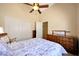 Bright primary bedroom with white closet and ceiling fan at 20739 N 106Th Ave, Peoria, AZ 85382
