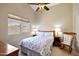 Sunlit bedroom features a ceiling fan and exterior view at 20739 N 106Th Ave, Peoria, AZ 85382