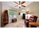 Relaxing bonus room with a comfortable chair, ceiling fan, and decorative elements at 20739 N 106Th Ave, Peoria, AZ 85382