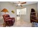 Cozy bonus room with comfortable seating, ceiling fan, and tile flooring at 20739 N 106Th Ave, Peoria, AZ 85382