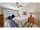 Serene main bedroom with bay windows, neutral walls, and a ceiling fan at 20739 N 106Th Ave, Peoria, AZ 85382