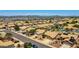 This aerial view shows a community of single-Gathering homes with desert landscaping and mountain views at 20739 N 106Th Ave, Peoria, AZ 85382