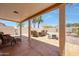 Covered patio featuring a dining table with seating and rock landscaping at 20739 N 106Th Ave, Peoria, AZ 85382