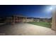 Backyard with a wooden pergola, swing, artificial turf, pavers, and landscape lighting at 2121 E Aquarius Pl, Chandler, AZ 85249