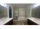 Bright bathroom with double sink vanity, soaking tub, and glass shower at 2121 E Aquarius Pl, Chandler, AZ 85249
