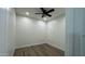 Well-lit bedroom with wood-look flooring, ceiling fan, and plantation shutters at 2121 E Aquarius Pl, Chandler, AZ 85249
