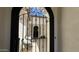 Charming courtyard view through the decorative iron gate, featuring neutral colors and seating at 2121 E Aquarius Pl, Chandler, AZ 85249