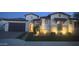 Inviting single-story home with lush lawn, stone accents, an arched entry, and a two car garage at 2121 E Aquarius Pl, Chandler, AZ 85249