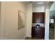 Hallway featuring a decorative built-in cabinet and modern artwork on a neutral colored wall at 2121 E Aquarius Pl, Chandler, AZ 85249