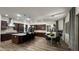 Gourmet kitchen with a center island, wood cabinetry, stainless appliances, and adjacent dining area at 2121 E Aquarius Pl, Chandler, AZ 85249