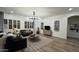 Elegant living room featuring modern chandelier, neutral walls, wood floors, and comfortable furnishings at 2121 E Aquarius Pl, Chandler, AZ 85249