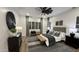 Well-lit main bedroom with carpeted floors, a bed, nightstands, and ceiling fan at 2121 E Aquarius Pl, Chandler, AZ 85249