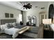 Spacious main bedroom featuring a ceiling fan and a view to the ensuite bathroom at 2121 E Aquarius Pl, Chandler, AZ 85249