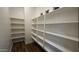 Spacious walk-in pantry with lots of shelving for optimal storage and organization at 2121 E Aquarius Pl, Chandler, AZ 85249