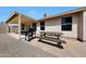 Covered patio area with outdoor kitchen and a picnic table at 23638 N 41St Ave, Glendale, AZ 85310