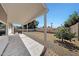 View of a covered backyard patio with a BBQ and a large, open yard at 23638 N 41St Ave, Glendale, AZ 85310