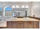 Bright bathroom with double sinks, wood cabinets, and large mirror at 23638 N 41St Ave, Glendale, AZ 85310