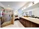Luxury bathroom with double sink vanity, tile shower and bright lighting at 23638 N 41St Ave, Glendale, AZ 85310