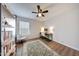A bedroom with wood-look floors, desk space, and a ceiling fan at 23638 N 41St Ave, Glendale, AZ 85310