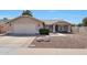 Charming single-story home showcasing a low maintenance desert-style front yard and a two-car garage at 23638 N 41St Ave, Glendale, AZ 85310