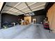 Open garage featuring custom overhead lighting and built-in cabinet storage at 23638 N 41St Ave, Glendale, AZ 85310